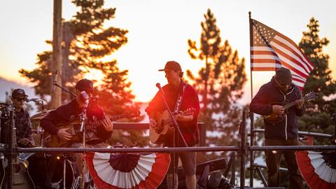 Band playing on a deck, American flag waving